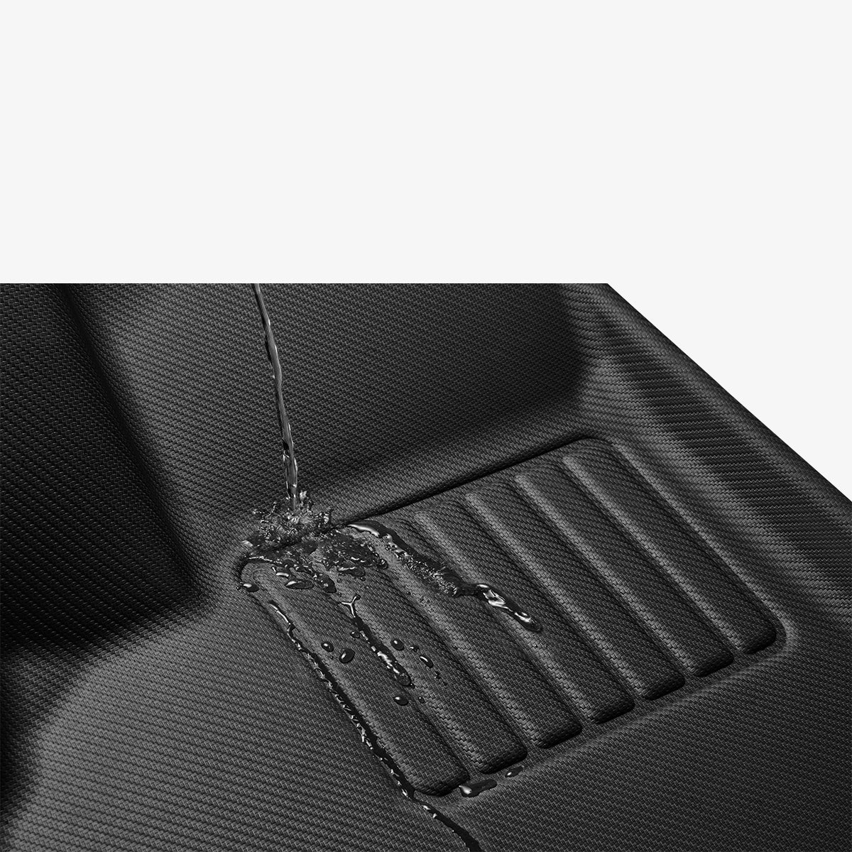 ACP07578 - Tesla Model 3 Highland WeatherBloc Floor Mat TLF-3H in Black showing the water resistant test