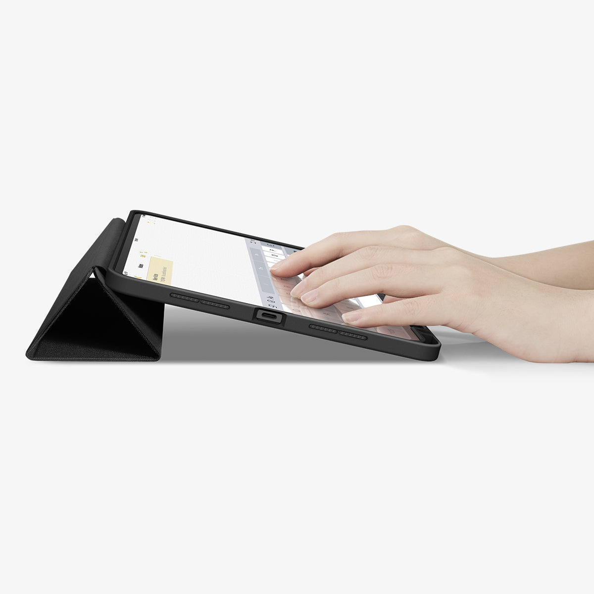 ACS07020 - iPad Pro 11-inch Case Urban Fit in Black showing the partial front with a hand typing on the device with a folded front cover propped up as a stand