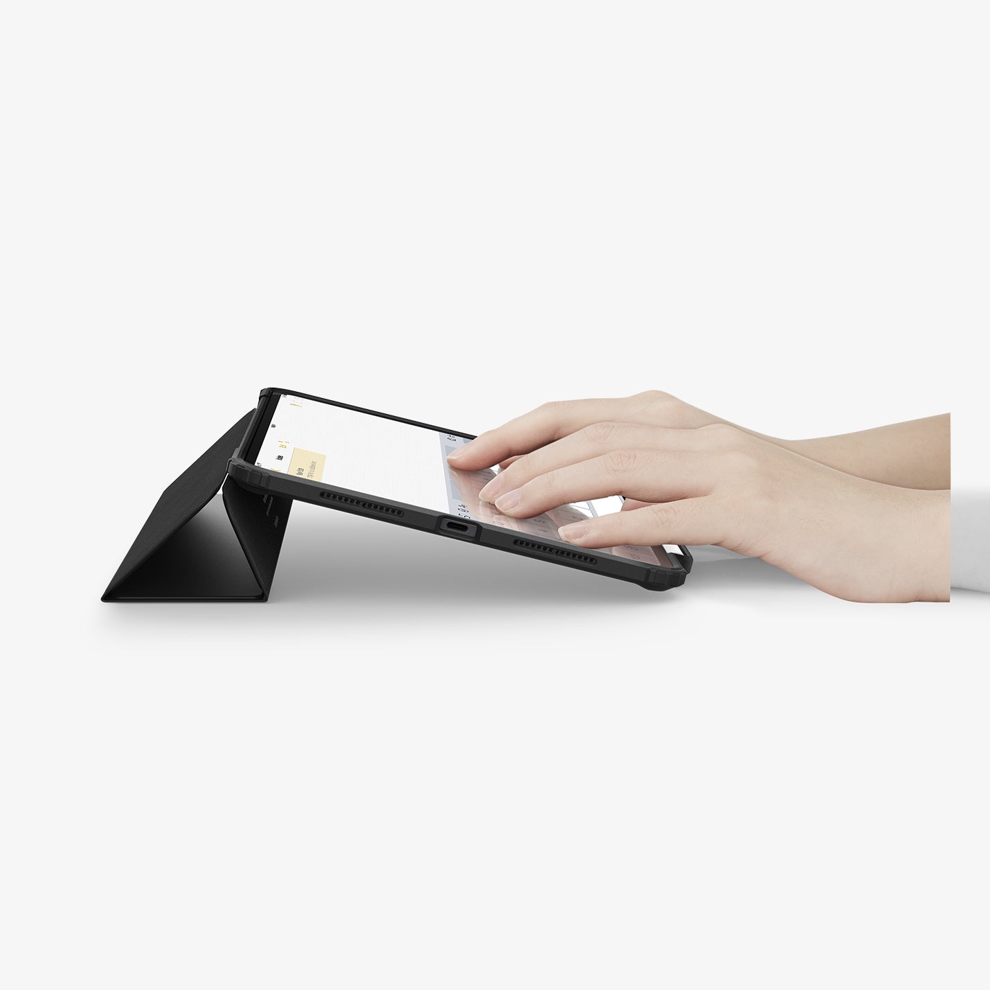 ACS07760 - iPad Pro 11-inch Case Ultra Hybrid Pro in Black showing the partial front with a hand typing on the device with a folded front cover propped up as a stand