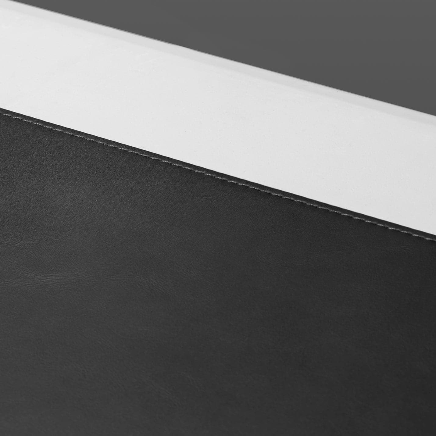 APP04762 - LD302 Desk Pad in black showing the side stitching zoomed in