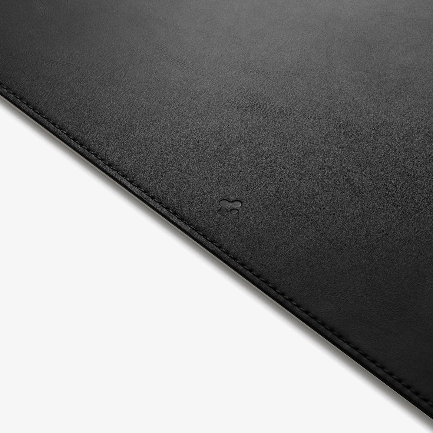 APP04762 - LD302 Desk Pad in black showing the front zoomed in on the Spigen logo