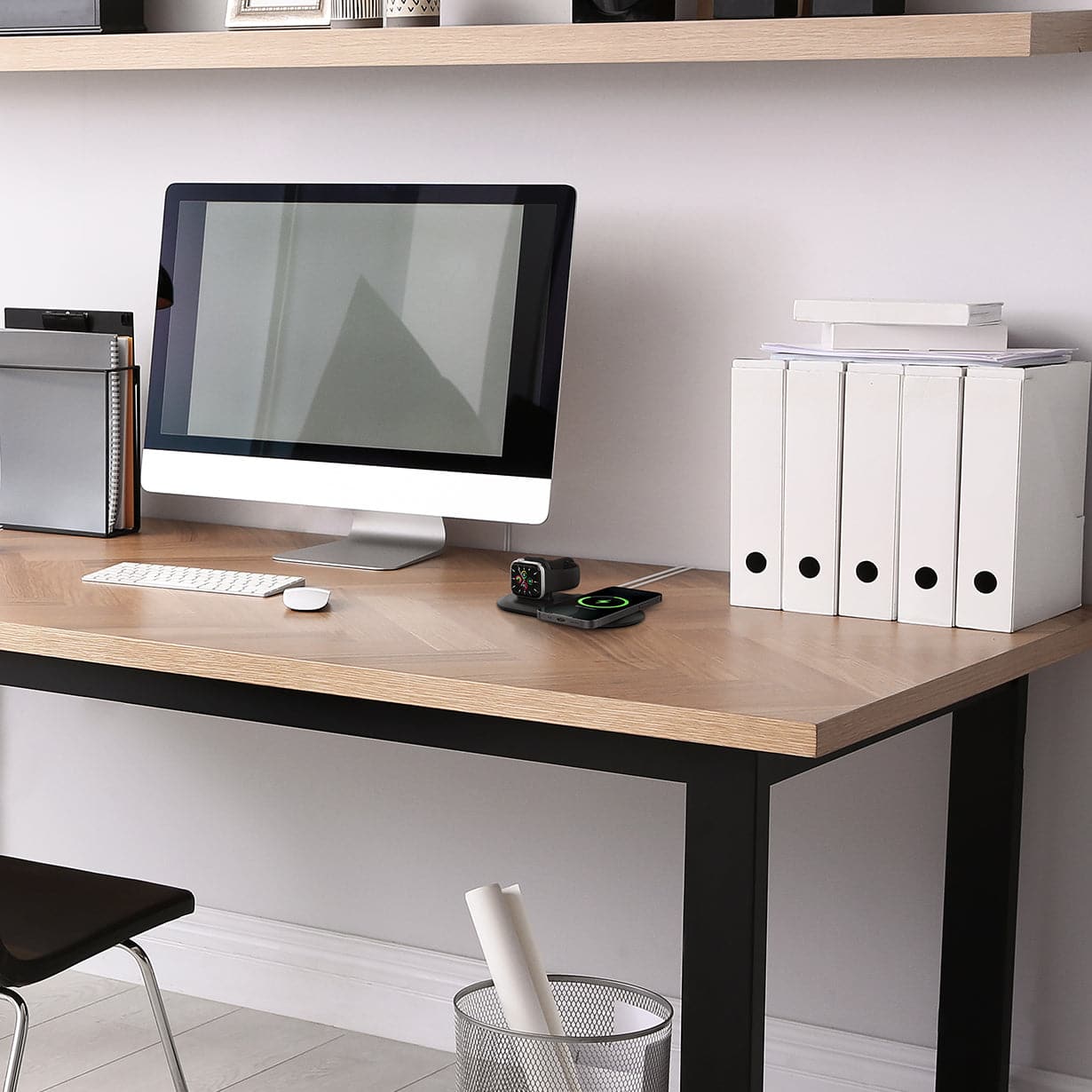 AMP02796 - Mag Fit Duo in black showing Apple Watch and iPhone charging on top of computer desk