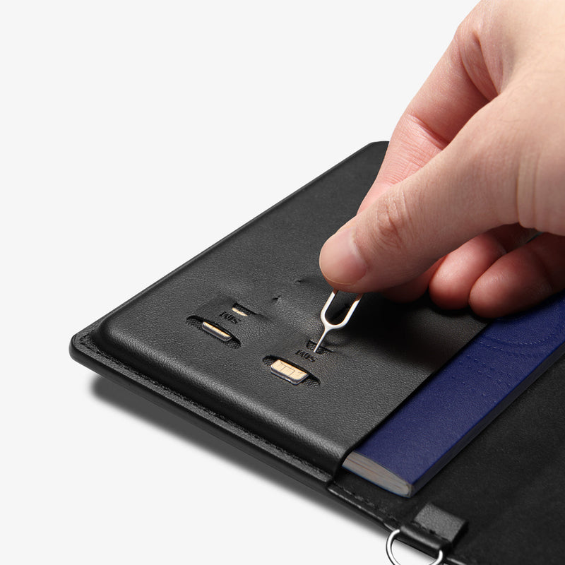 AFA05538 - Passport Holder in black showing the inner with sim slots, taking out the pin ejector to remove the sim cards inserted