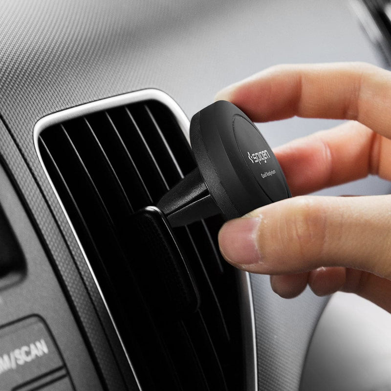 SGP11583 - Spigen Kuel Q11 Magnetic Air Vent Car Mount showing a hand placing car mount into airvent