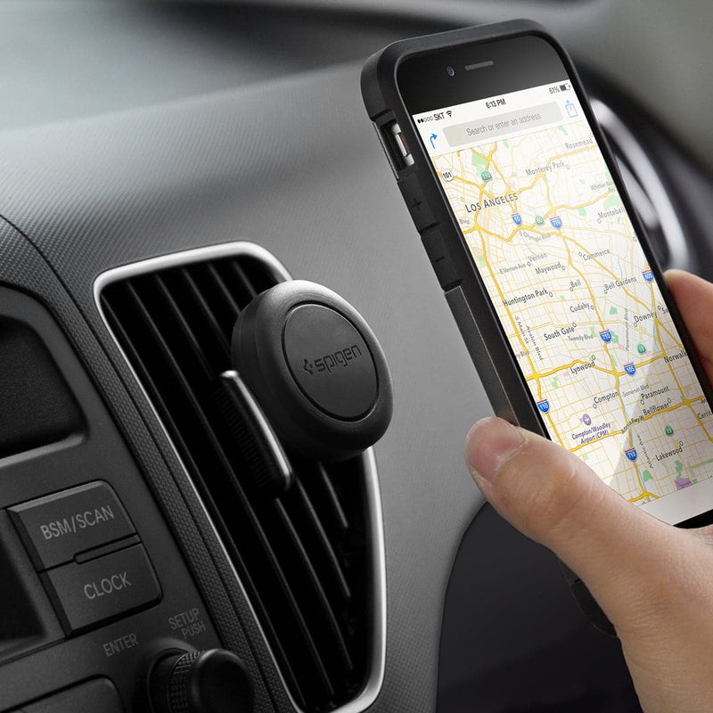 SGP11583 - Spigen Kuel Q11 Magnetic Air Vent Car Mount showing a hand placing a device onto car mount inside of vehicle