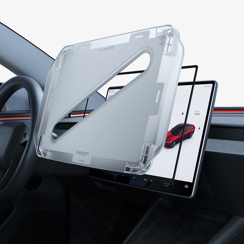 AGL07151 - Tesla Model Y & 3 (2024) Protector GLAS.tR EZ Fit in Clear showing the front of ez fit tray hovering in front of a screen protector and a device inside a vehicle