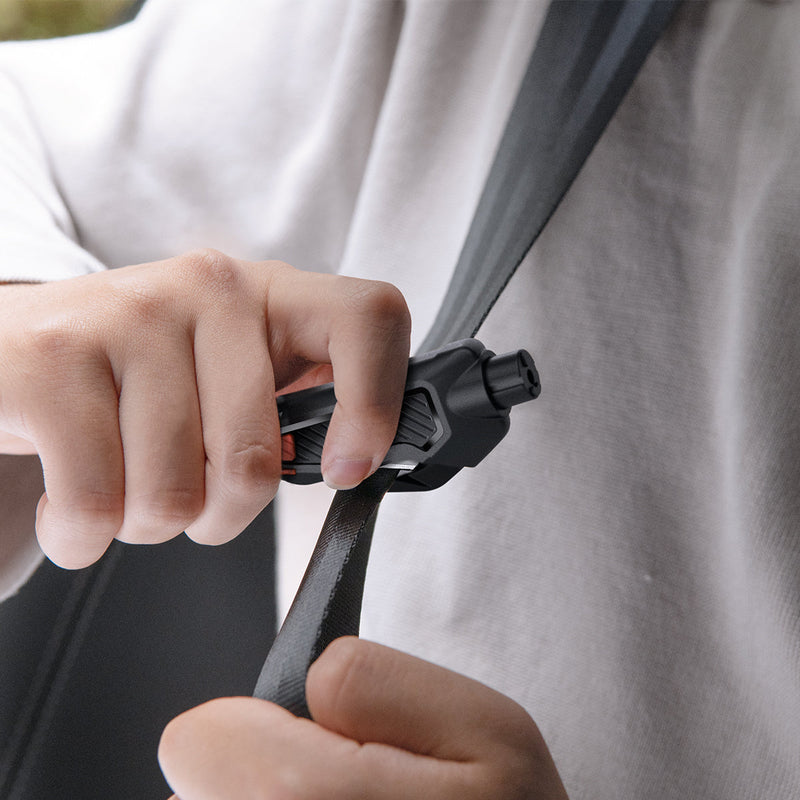 ACP06988 - Car Escape Tool in Black showing a person using the tool to cut through a jammed seatbelt