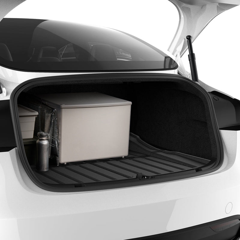 ACP07612 - Tesla Model 3 Highland Trunk Mat Liner TLT-3H in Black showing the partial front of a big size mat liner installed in a vehicle's compartment with storages boxes